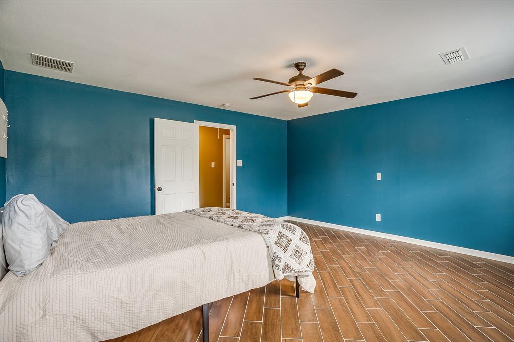 1050 Hampel Road Palmer, TX 75152 - Photo 27 of 35 a bedroom with a large bed and a chandelier
