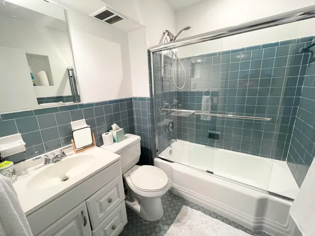 a bathroom with a toilet a sink and bathtub