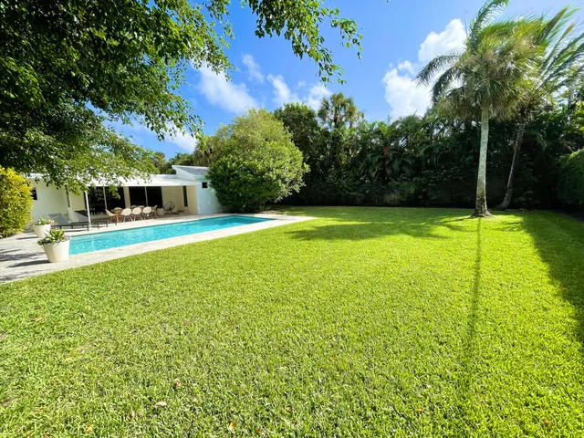 a view of a swimming pool with an outdoor space and seating area