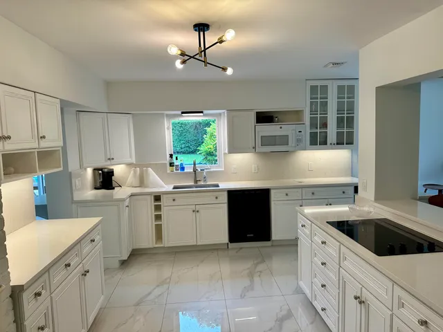 a kitchen with a sink stove and microwave