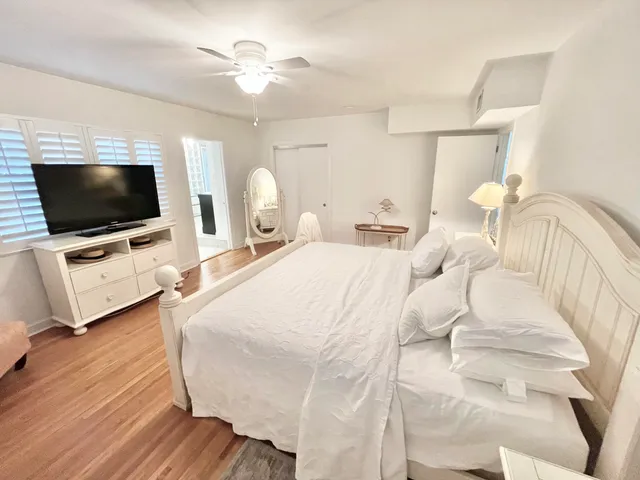 a bedroom with a bed window and a flat screen tv