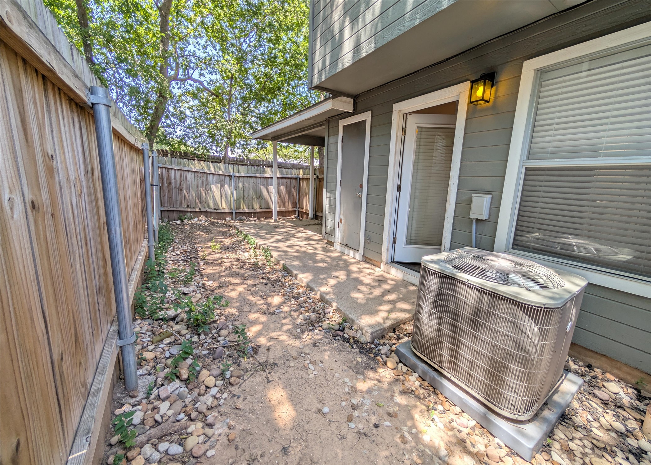 8816 Schick Road, Unit D Austin, TX 78729 - Photo 18 of 19 Backyard has rock coverage and private fence