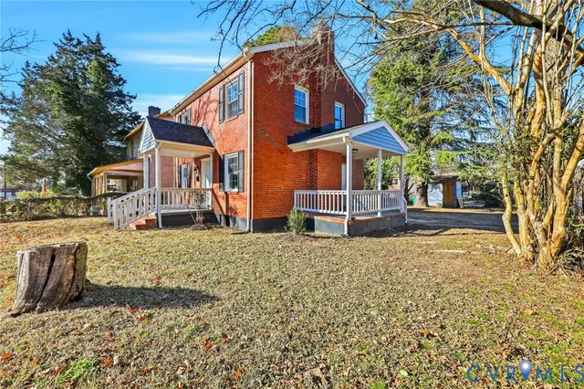 a view of a house with a yard covered in snow