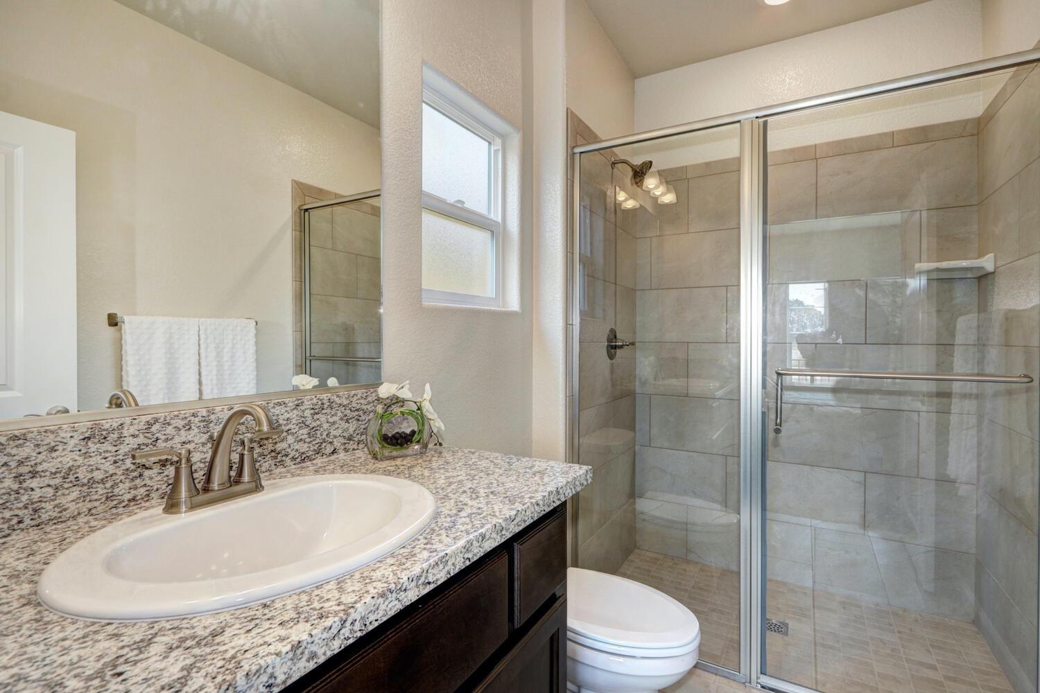 1071 Hogan Road Galt, CA 95632 - Photo 5 of 17 *Guest Suite Bathroom (walk-in shower with tiled surround).
