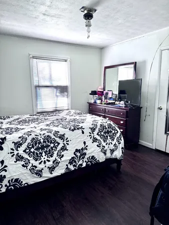 a bed sitting in a bedroom next to a window
