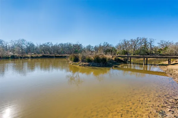 a view of a lake with houses in the back