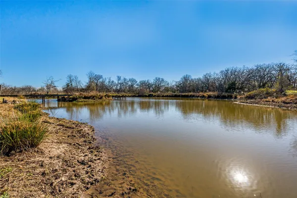 a view of a lake with houses in the back