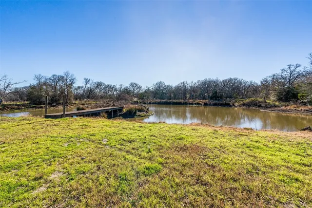 a view of a lake with houses in the back