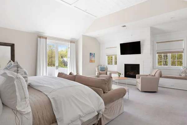 a spacious bedroom with a large bed and a fireplace