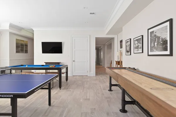 a room with furniture pool table and window