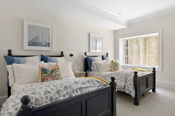 a bedroom with two beds and a window