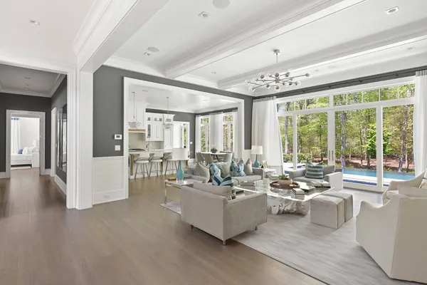 a living room with furniture and large windows