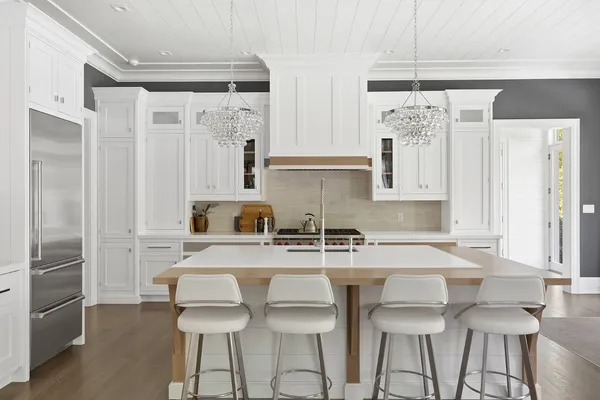 a kitchen with stainless steel appliances a sink and a refrigerator