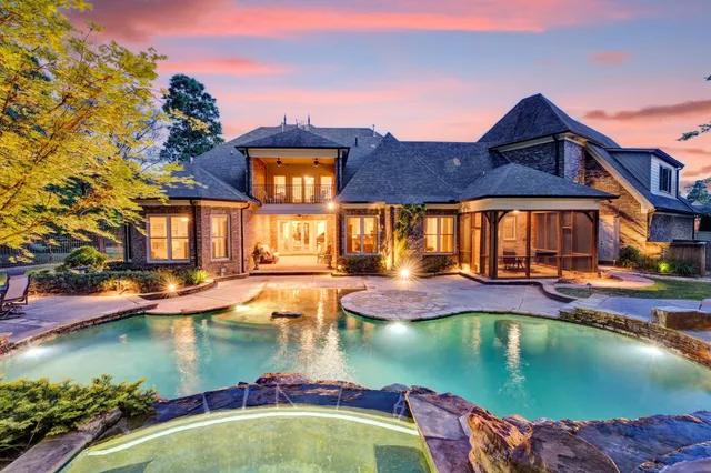 a view of a house with pool and a yard