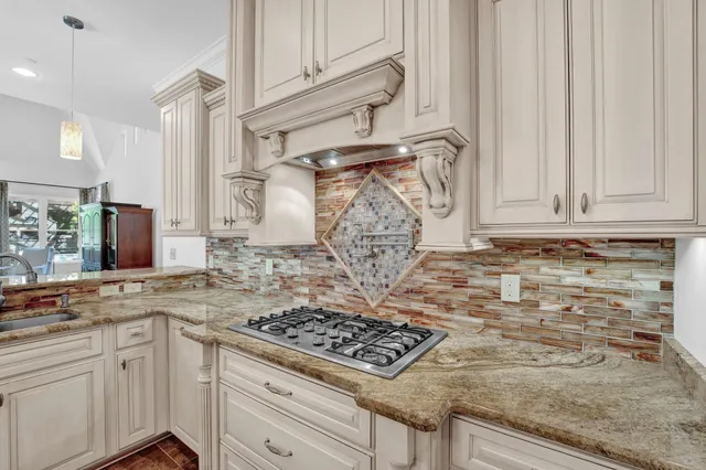 a kitchen with white cabinets and appliances