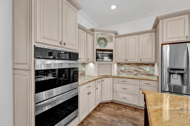 a kitchen with stainless steel appliances granite countertop a stove and cabinets
