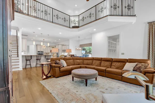 a living room with furniture a rug and a chandelier