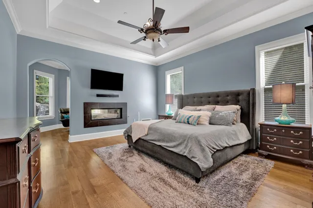 a spacious bedroom with a bed and a flat screen tv