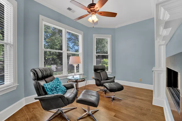 a living room with furniture ceiling fan and a window