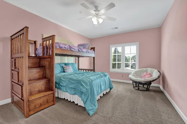 a bedroom with a bed and large window