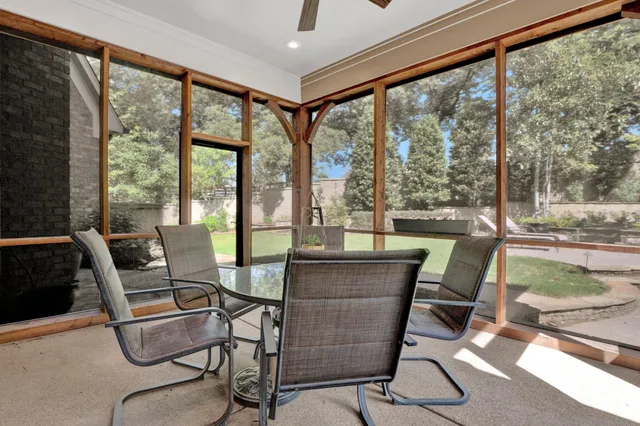 a dining room with furniture and floor to ceiling windows