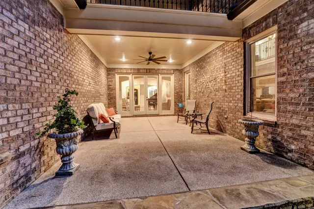 a view of a patio with table and chairs and potted plants