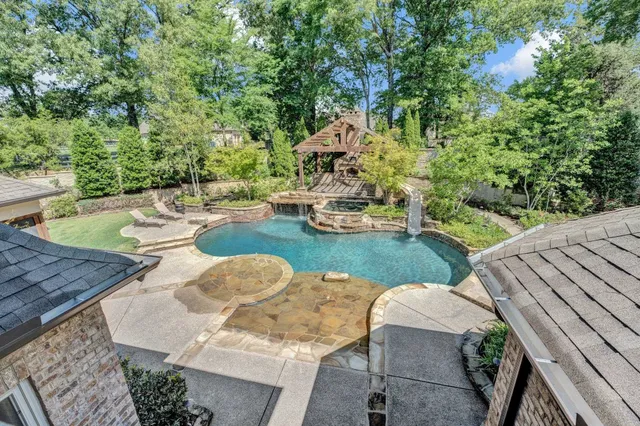 a view of yard from deck with patio