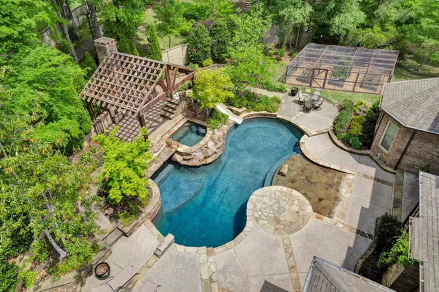 an aerial view of a house with garden space and street view