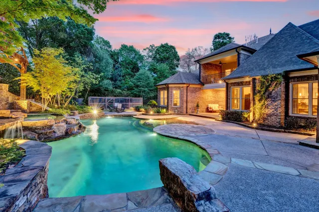 a view of a house with swimming pool yard and sitting area
