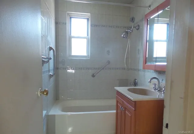 a bathroom with a sink a bathtub and shower