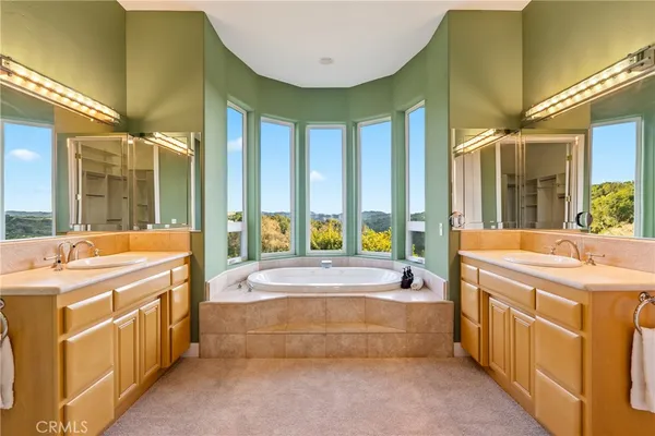 a bathroom with a granite countertop sink toilet a large mirror and shower