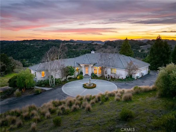 an aerial view of a house with a big yard
