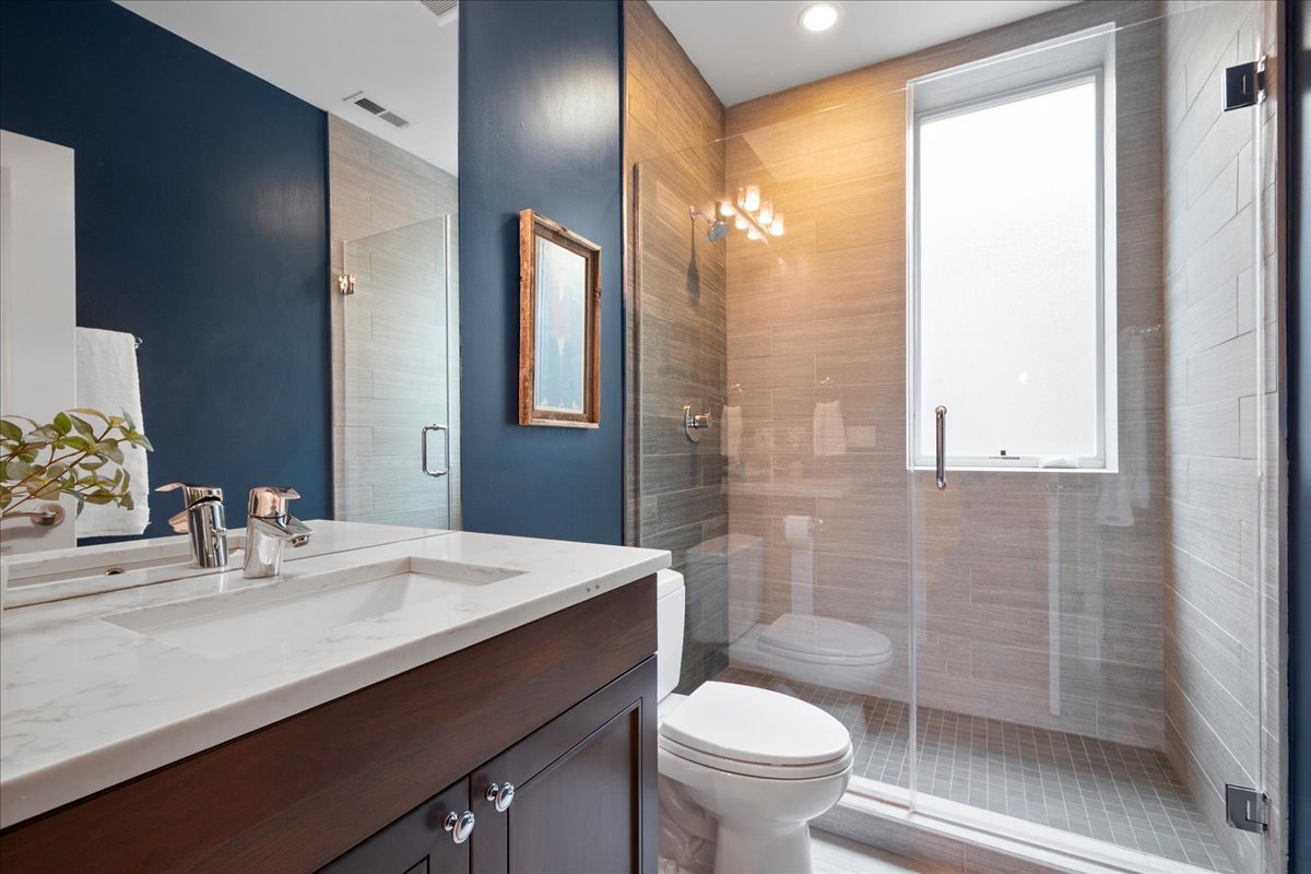 2921 Simpson Street Evanston, IL 60201 - Photo 30 of 41 a bathroom with a sink a toilet and shower