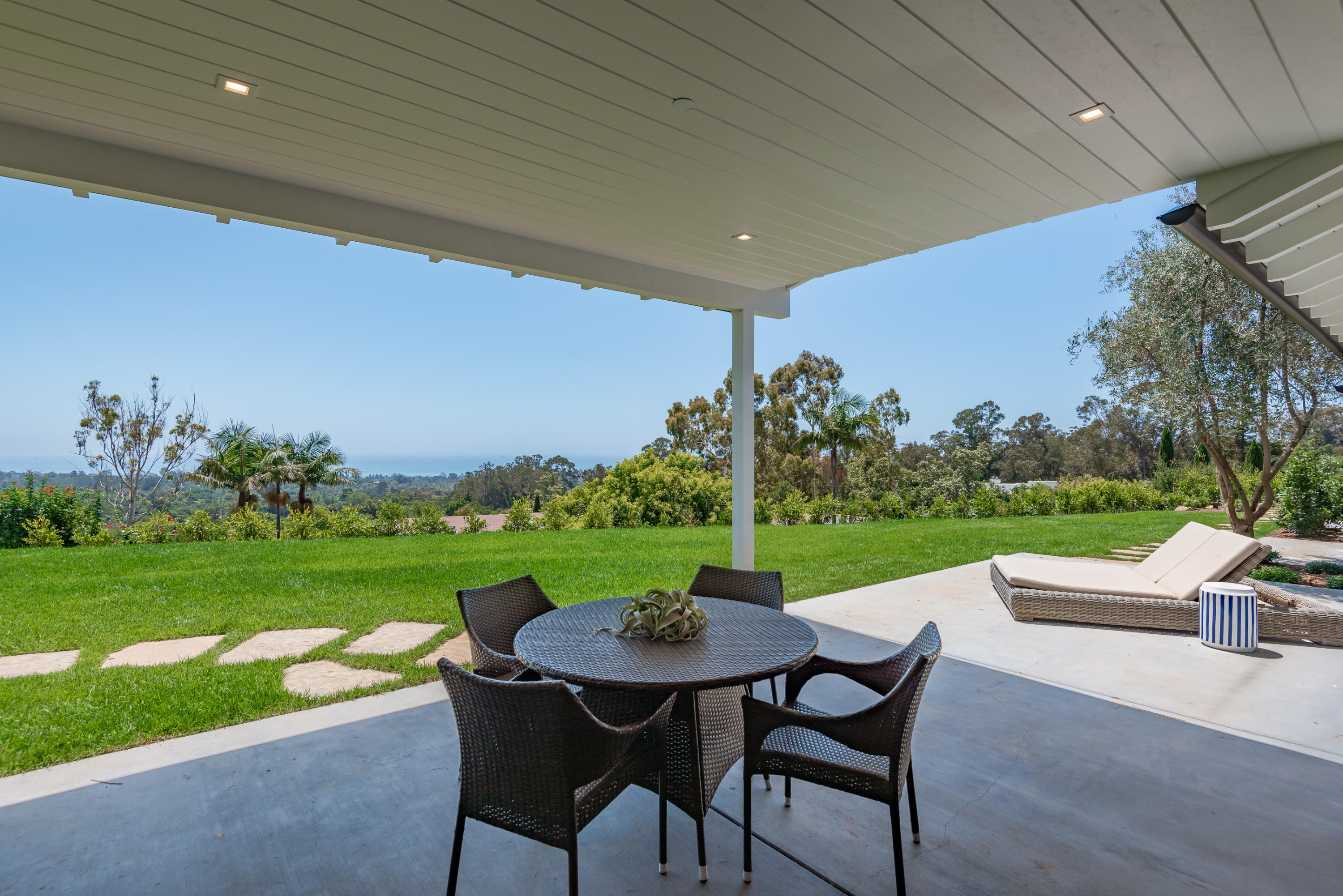 950 Brooktree Road Santa Barbara, CA 93108 - Photo 24 of 37 a view of a patio with a table chairs and a yard