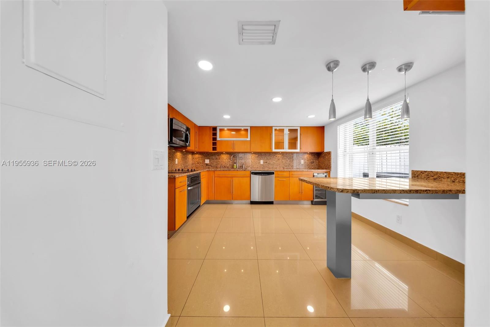6960 Southwest 54th Street Miami, FL 33155 - Photo 16 of 55 a kitchen with stainless steel appliances granite countertop a sink and a refrigerator