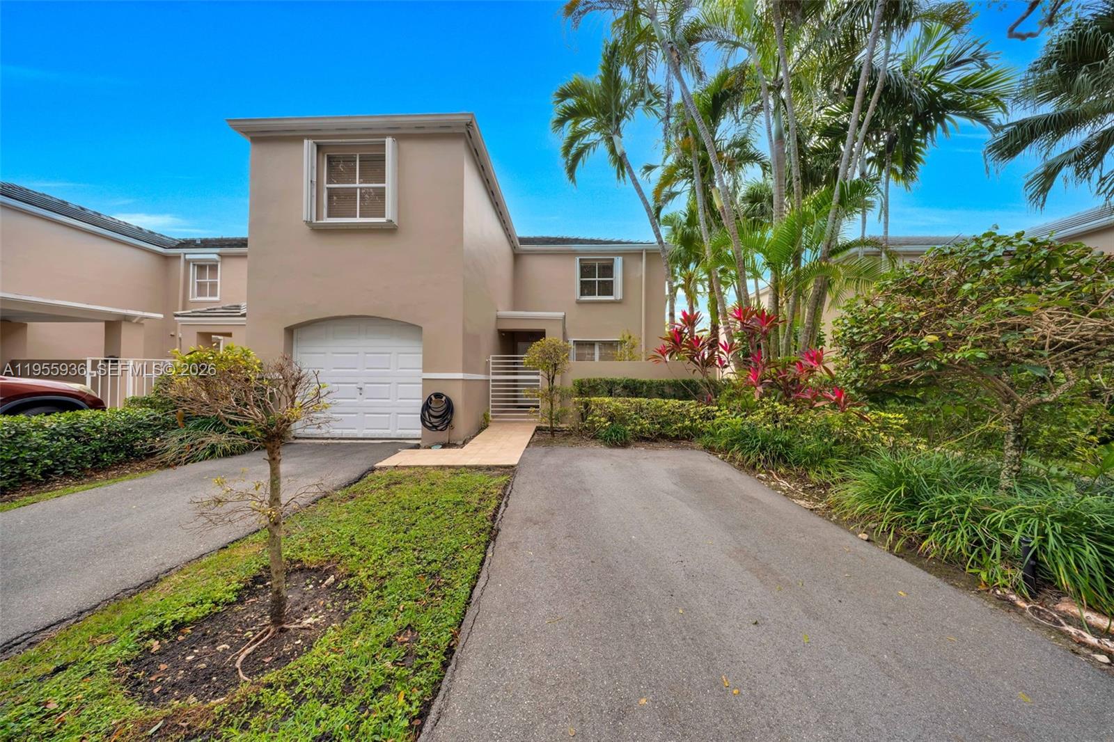 6960 Southwest 54th Street Miami, FL 33155 - Photo 2 of 55 a front view of a house with a yard and a garage