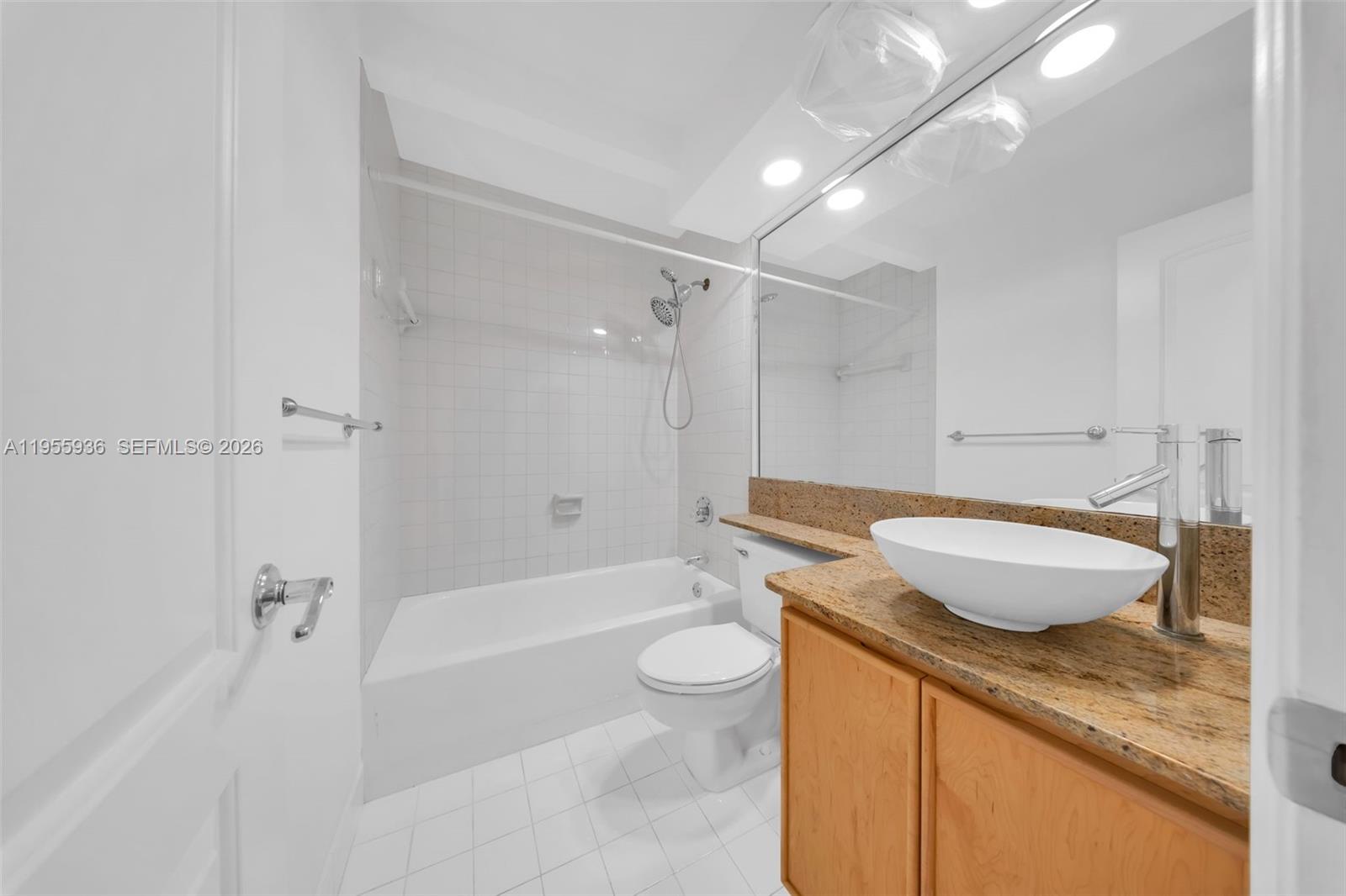 6960 Southwest 54th Street Miami, FL 33155 - Photo 40 of 55 a bathroom with a granite countertop sink a toilet and shower