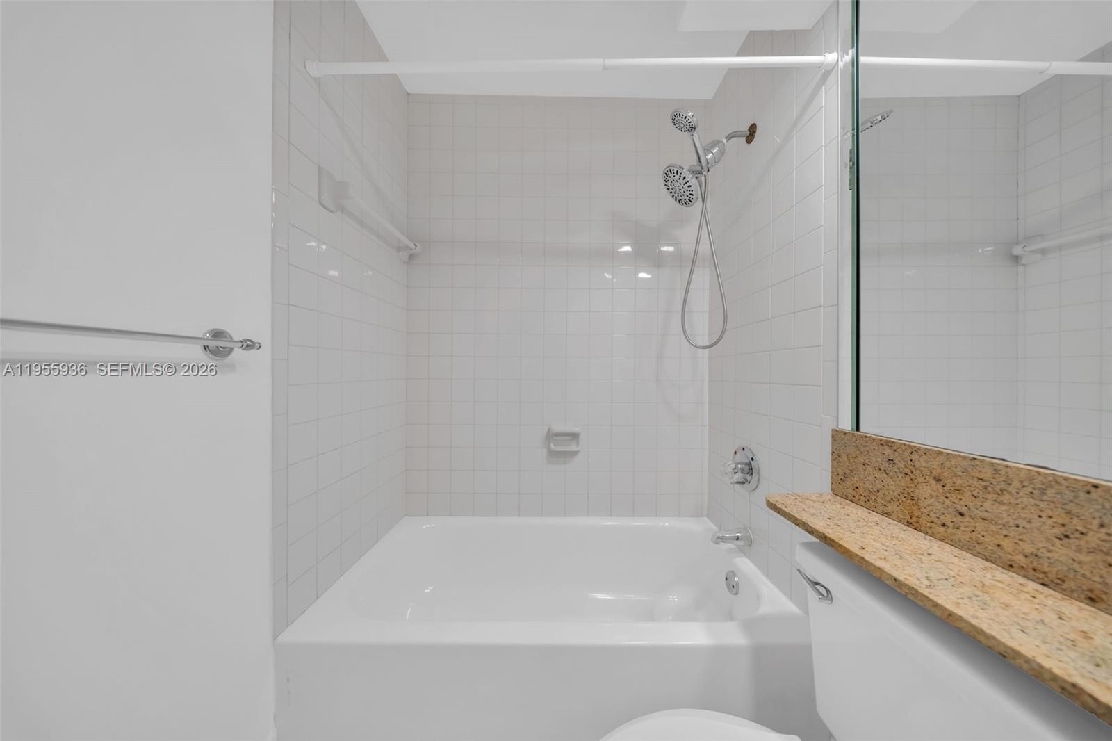 6960 Southwest 54th Street Miami, FL 33155 - Photo 42 of 55 a bathroom with a granite countertop bathtub shower and sink