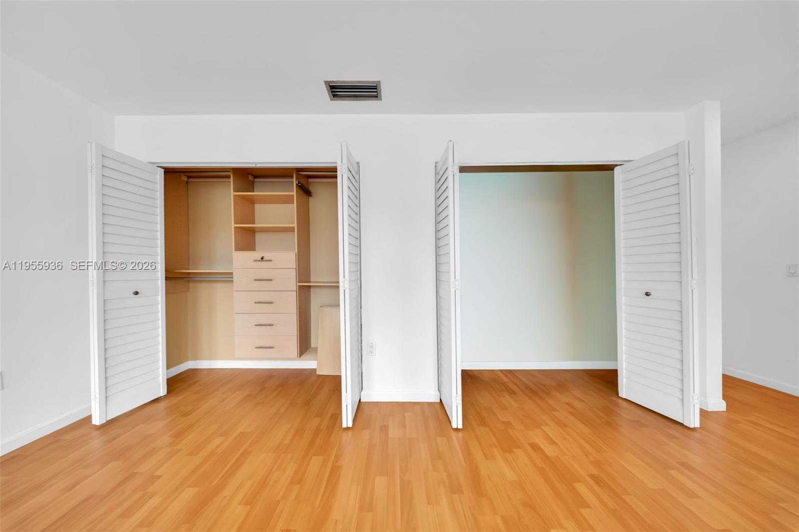 6960 Southwest 54th Street Miami, FL 33155 - Photo 47 of 55 an empty room with wooden floor and closet
