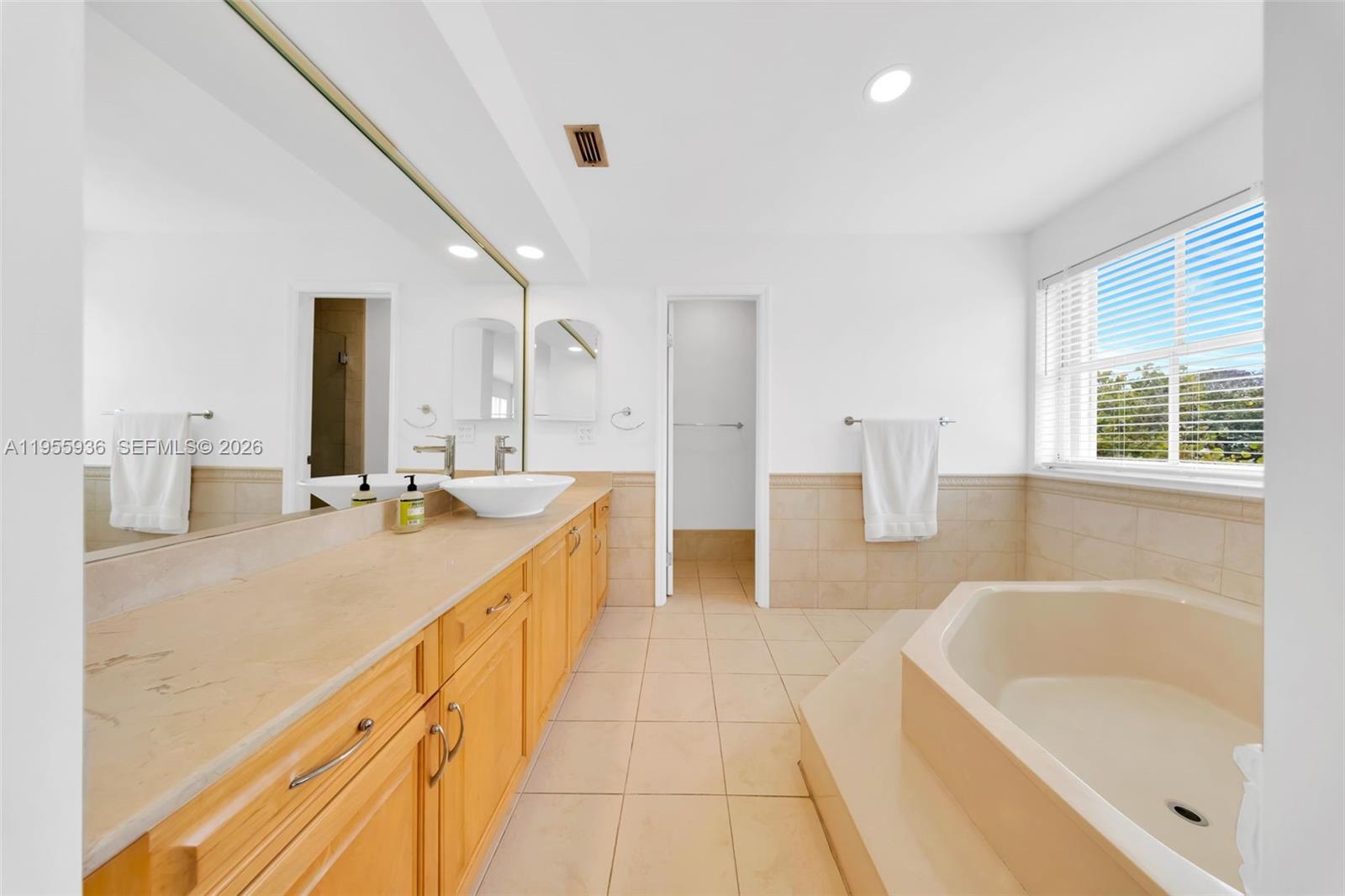 6960 Southwest 54th Street Miami, FL 33155 - Photo 48 of 55 a spacious bathroom with a tub sink and mirror
