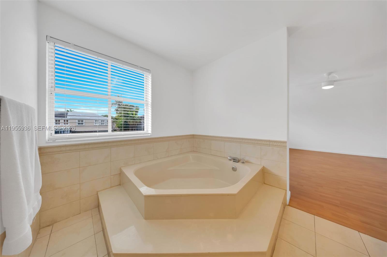 6960 Southwest 54th Street Miami, FL 33155 - Photo 49 of 55 a bath tub sitting in a bathroom next to a window