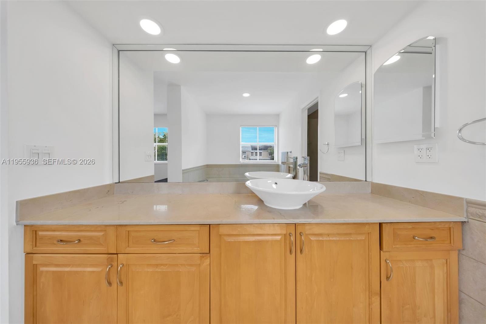 6960 Southwest 54th Street Miami, FL 33155 - Photo 51 of 55 a bathroom with a granite countertop sink and a mirror