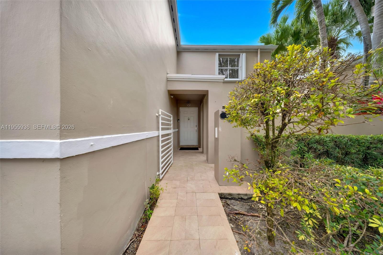 6960 Southwest 54th Street Miami, FL 33155 - Photo 7 of 55 a view of a pathway of a house with potted plants