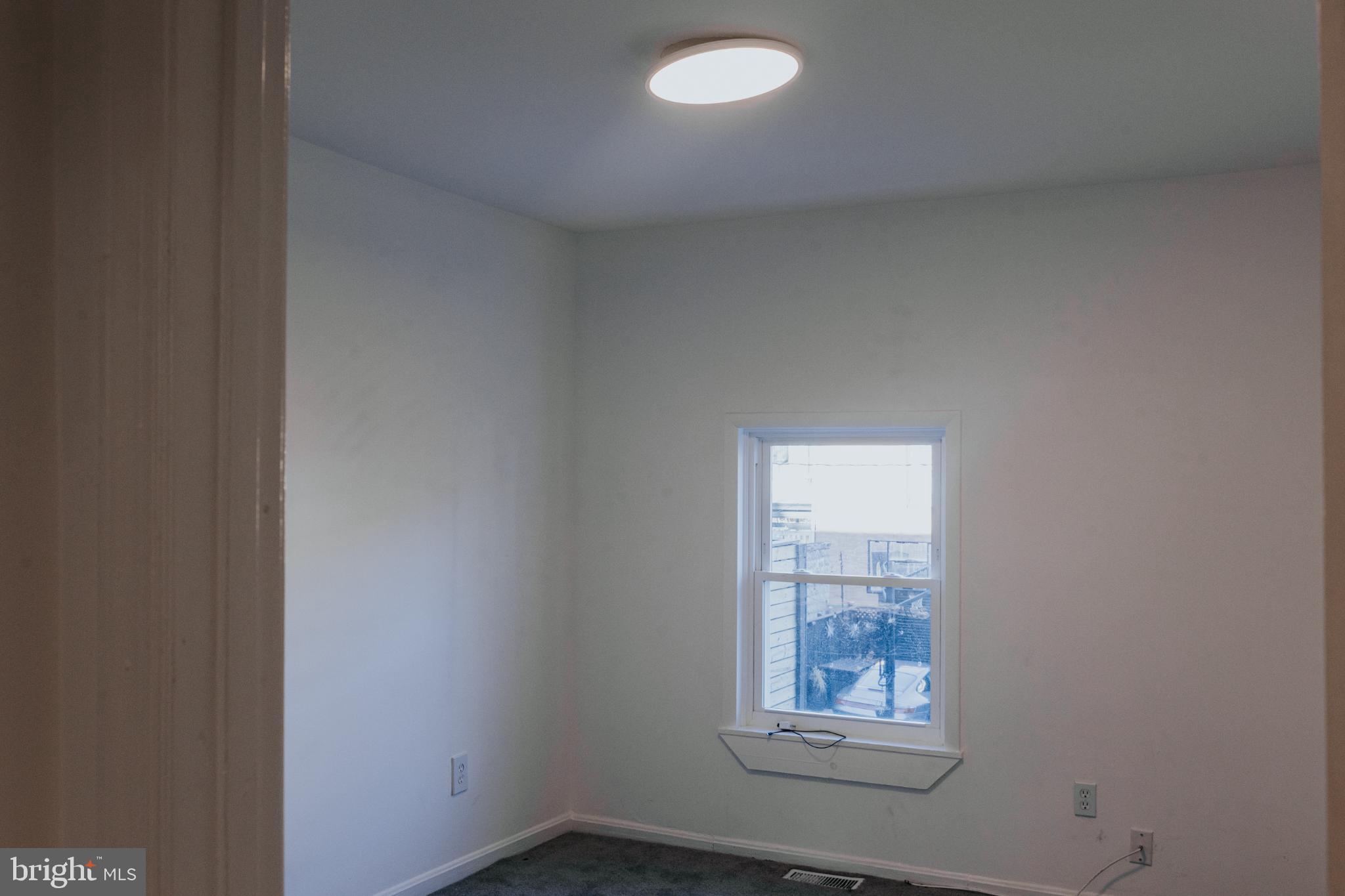 2511 Madison Avenue, Unit 1 Baltimore, MD 21217 - Photo 11 of 23 an empty room with a window