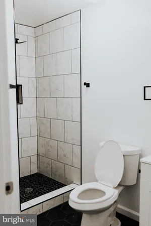 a bathroom with a toilet and a shower