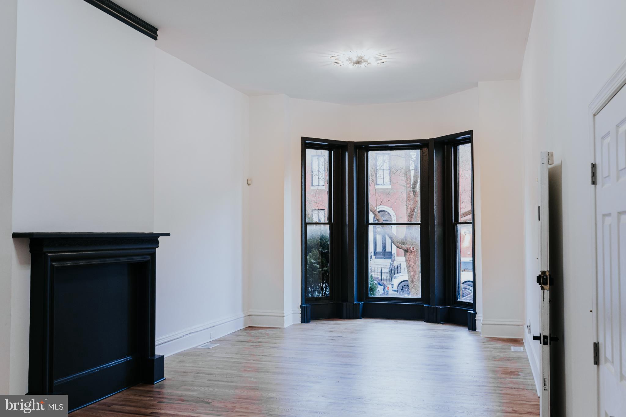 2511 Madison Avenue, Unit 1 Baltimore, MD 21217 - Photo 3 of 23 wooden floor in an empty room with a window