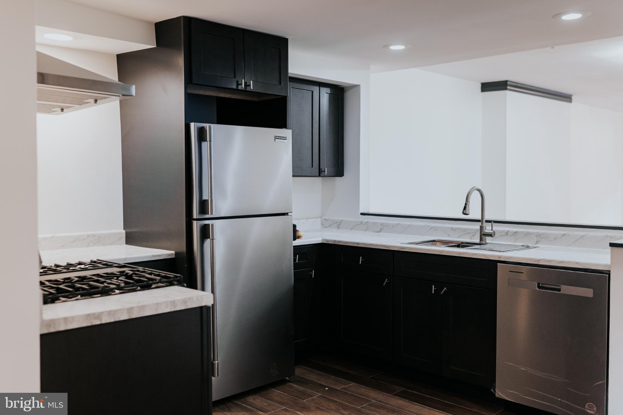 2511 Madison Avenue, Unit 1 Baltimore, MD 21217 - Photo 5 of 23 a kitchen with a refrigerator and a sink