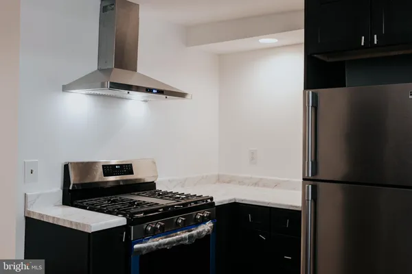 a kitchen with a refrigerator and a stove