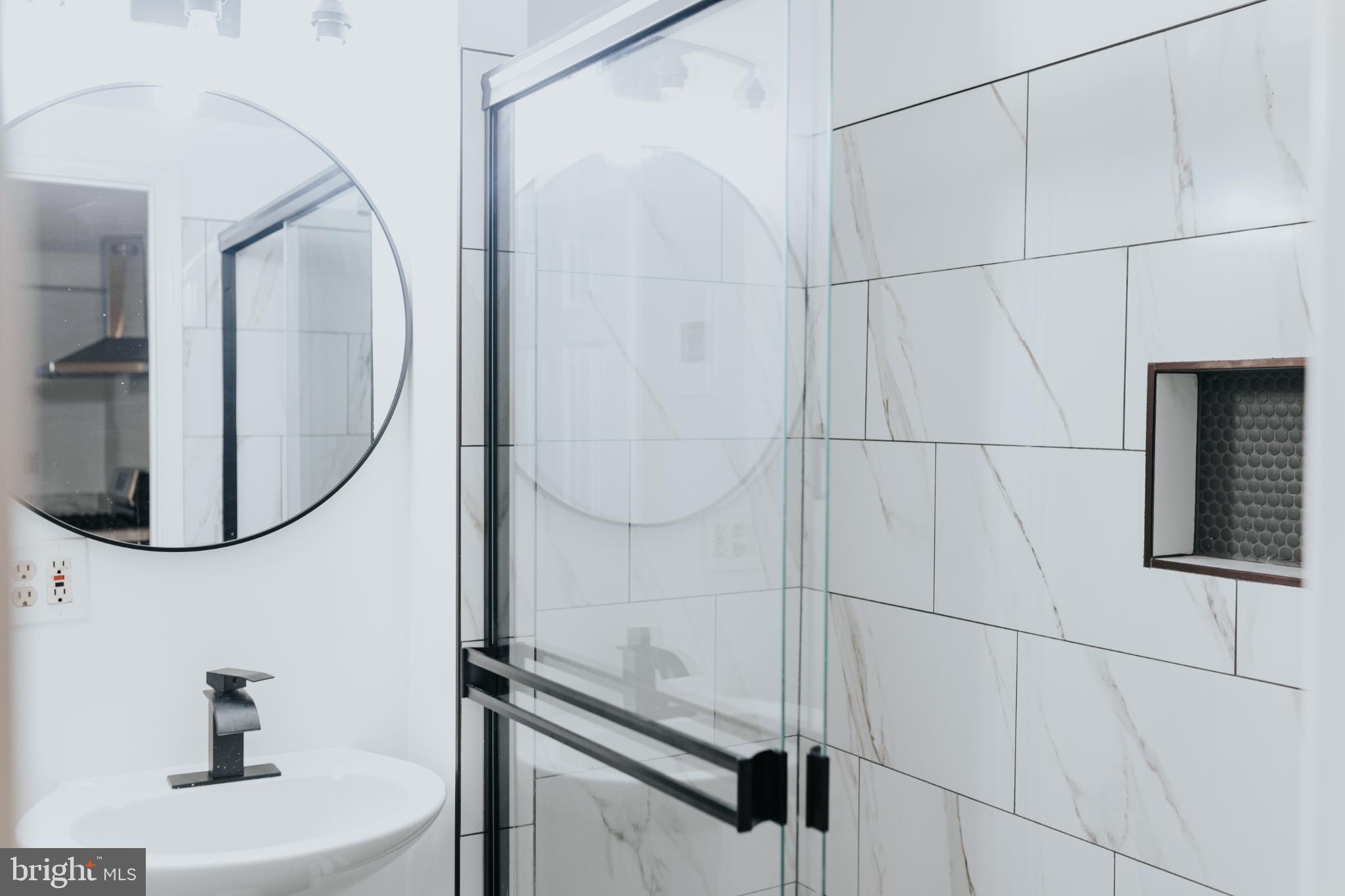 2511 Madison Avenue, Unit 1 Baltimore, MD 21217 - Photo 7 of 23 a bathroom with a sink and mirror
