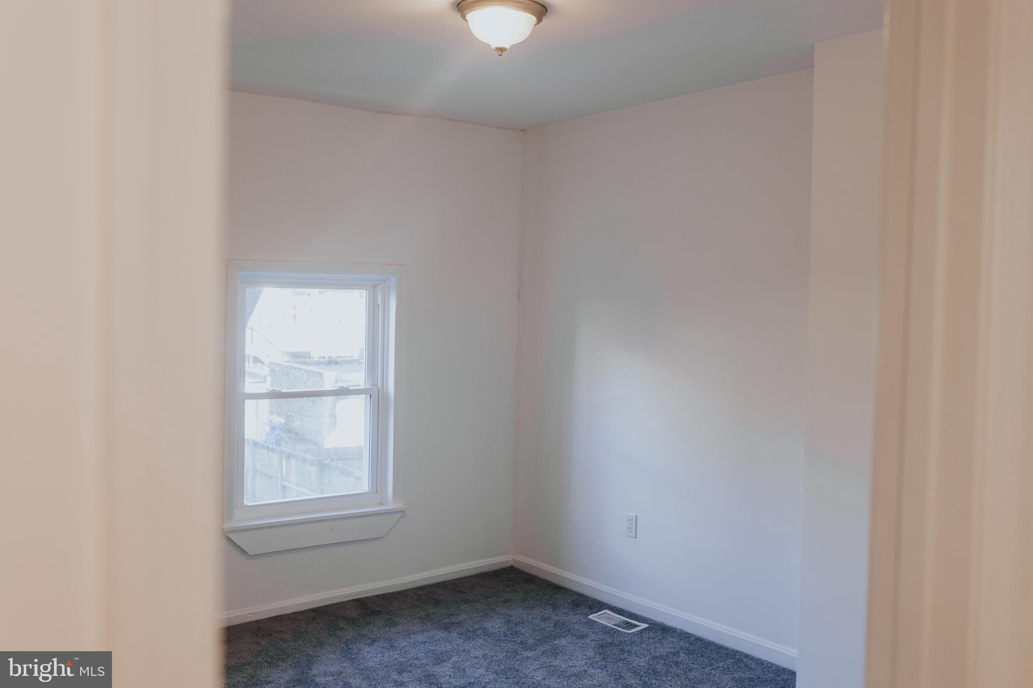 2511 Madison Avenue, Unit 1 Baltimore, MD 21217 - Photo 10 of 23 an empty room with a window
